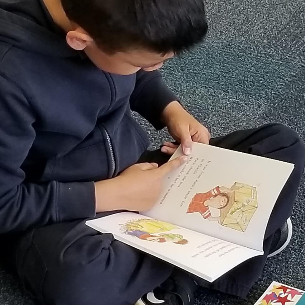 A boy reading a book with VRP
